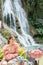 Young Asian woman sitting on a chair In front of the Khoun Moung Keo Waterfall