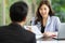 Young  asian woman sitting smiling and talking to the company interviewer for job application in the office. Selective focus on