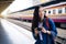 Young Asian woman smile holding camera in hand. Young passenger