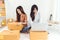 Young Asian woman startup small business entrepreneur SME distribution warehouse with parcel mail box. Owner home office concept.