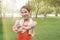 Young Asian woman stretching her hands before run in park with sunshine effect. Fitness and exercise concept.