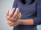 Young Asian woman suffering wrist pain from housework or Carpal tunnel syndrome symptom. Health care and medical concept