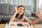 Young asian woman takeaway eating donut junk food enjoy to selfie update on social in living room