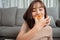 Young asian woman takeaway eating donut junk food in living room enjoy happiness at home, Fast food