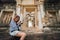 Young asian woman taking photo of prasat sdok kok thom in thailand