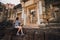 Young asian woman taking photo of prasat sdok kok thom in thailand with camera.