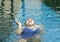 Young Asian woman about to drown because of leg cramps in swimming pool