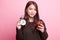 Young Asian woman with tomato juice and clock.