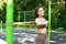 Young asian woman training with resistance band at the street sports ground