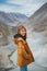 Young asian woman traveler enjoy traveling at confluence of zanskar and indus rivers in leh.