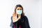 Young Asian woman using face mask with hand showing protection concept of Corona virus or Covid-19 virus