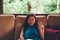 Young Asian woman during vacation relaxing on the sofa with big window behind her. woman on summer vacation in Bali