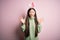 Young asian woman wearing cute easter bunny ears over pink background celebrating crazy and amazed for success with arms raised