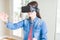 Young asian woman wearing virtual reality glasses smiling and concentrated playing video games