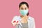 Young asian woman wore a gray undershirt, Blue shirt and protective masks against virus and air pollution,hand holding red heart,