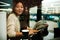 Young Asian Woman Work At Cafe With Window Reflection.