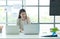 Young asian woman working at a call center Consulting about stock investment information with customers calling for advice