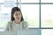 Young asian woman working at a call center Consulting about stock investment information with customers calling for advice