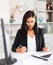 Young asian woman working in office and signs documents