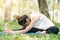 Young asian woman yoga outdoors keep calm and meditates while practicing yoga.