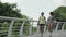 young asian women friends walking relaxing talking while exercising outdoors