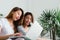 Young asian women LGBT lesbian happy couple sitting on sofa buying online using laptop.