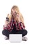 Young astonished blondie woman sitting with laptop and mobile ph