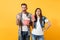 Young astonished couple woman and man watching movie film on date holding bucket of popcorn and plastic cup of soda or