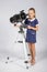 Young astronomer sets up a telescope and looked into the frame