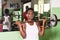 Young athlete doing weight lifting in a gym.