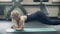 Young athlete makes exercises a plank with rotation in the gym. Attractive woman.