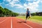 Young athlete runs on a treadmill at the stadium