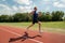 Young athlete runs on a treadmill at the stadium