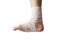 Young athlete\'s leg has ankle pain and Elastic Bandage is attached to the ankle. Concept of health