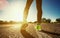 Young athlete in sneakers makes summer morning workout and exercises.