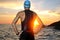 Young athlete triathlon in front of a sunrise