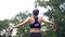 Young athlete woman in sport outfit engaged in fitness on the sports field in the park.