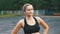 Young athlete woman in sport outfit engaged in fitness on the sports field in the park.