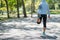 Young athlete woman streching in the park outdoor, female runner warm up ready for jogging on the road outside, asian Fitness walk