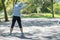 Young athlete woman streching in the park outdoor, female runner warm up ready for jogging on the road outside, asian Fitness walk