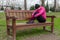 Young athlete woman tired or depressed resting on a bench