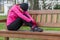 Young athlete woman tired or depressed resting on a bench