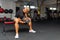 Young athlete Working out biceps at the gym.Closeup muscular young man lifting weights in gym on a dark background