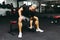 Young athlete Working out biceps at the gym.Closeup muscular young man lifting weights in gym on a dark background.Toned