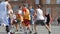 Young athletes play streetball in outdoors (slow motion)