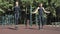 Young athletic couple jumping on the skipping rope outdoors