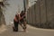 Young athletic and fit black African American runner in pain holding his ankle after suffering medical problem with injuried