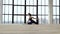 Young athletic girl doing sports in modern studio with big windows