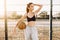 Young athletic girl, outdoors, posing with a basketball. Sport, fashion