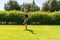 Young athletic man doing handstands at the park in